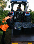 Blind Corner Bernard - Organic and Biodynamic Preservative Free Margaret River Cabernet during harvest. A worker loads buckets of hand-picked grapes onto a trailer, another drives the tractor and trailer down the vine row