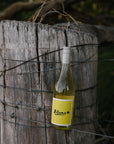 Bottle of Blind Corner Organic and biodynamic Blanc, from Margaret River, leaning on a fence post