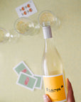 Live the Orange* in Colour life. Blind Corner Organic and Biodynamic Margaret River Orange* in Colour Skin Contact Blend being poured into glasses, playing cards scattered around it