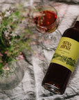 Blind Corner Organic and Biodynamic Margaret River Pinot Grigio on a picnic blanket with a freshly poured glass and bunch of flowers