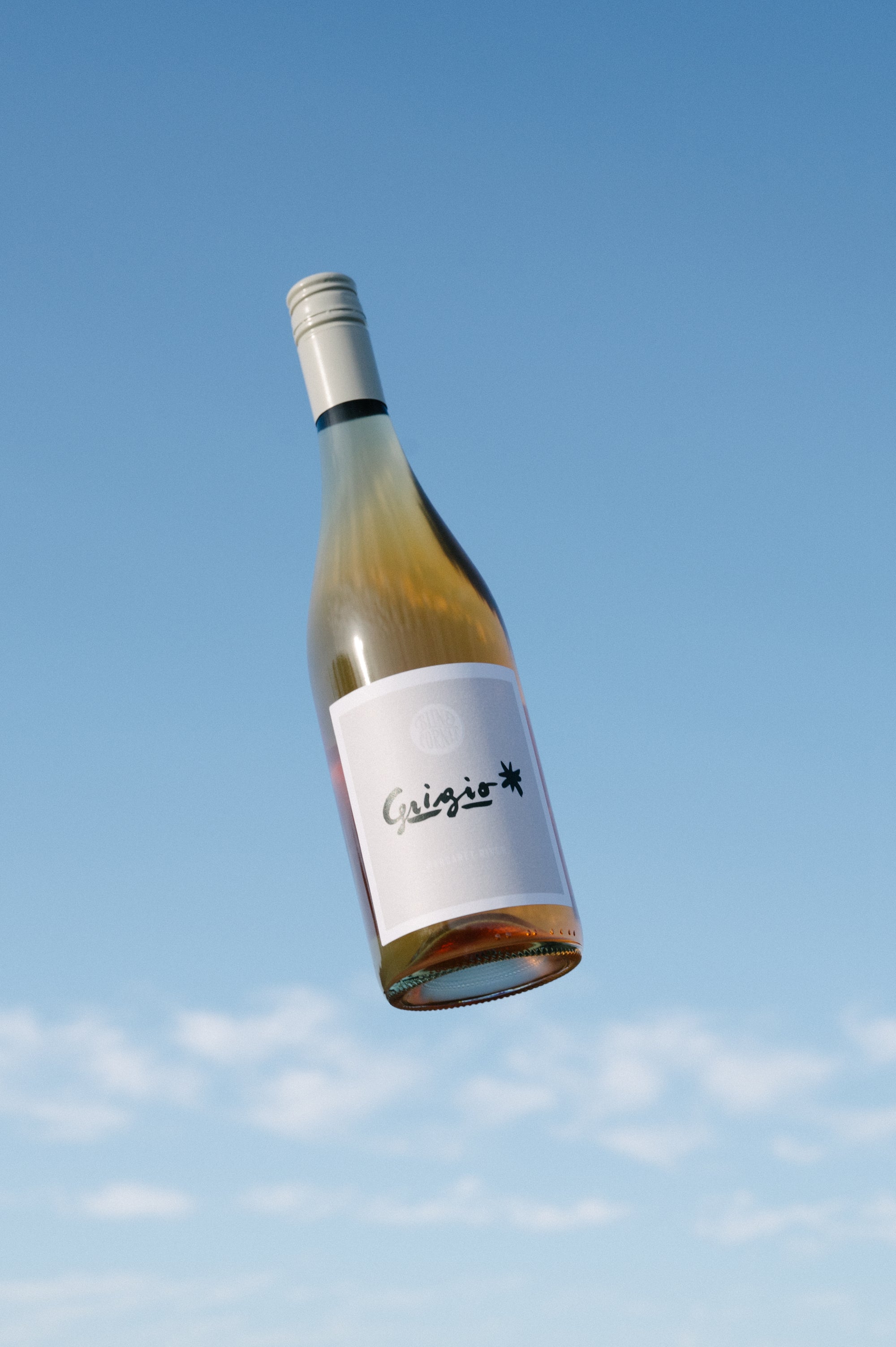 Blind Corner Organic Biodynamic Margaret River Grigio Bottle against a bright blue sky