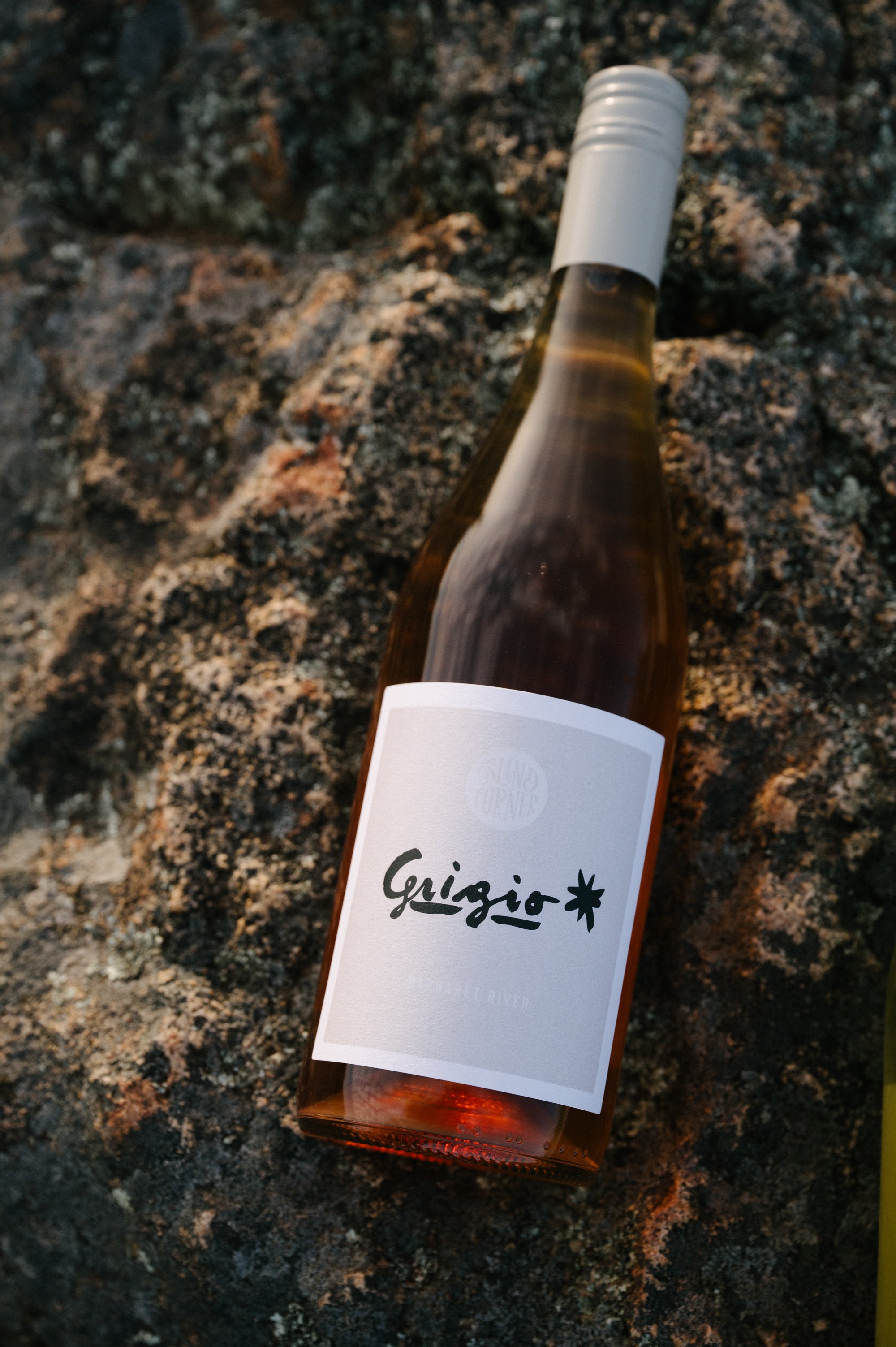 Bottle of Blind Corner Organic Biodynamic Grigio wine on a textured stone surface