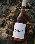 Bottle of Blind Corner Organic Biodynamic Grigio wine on a textured stone surface