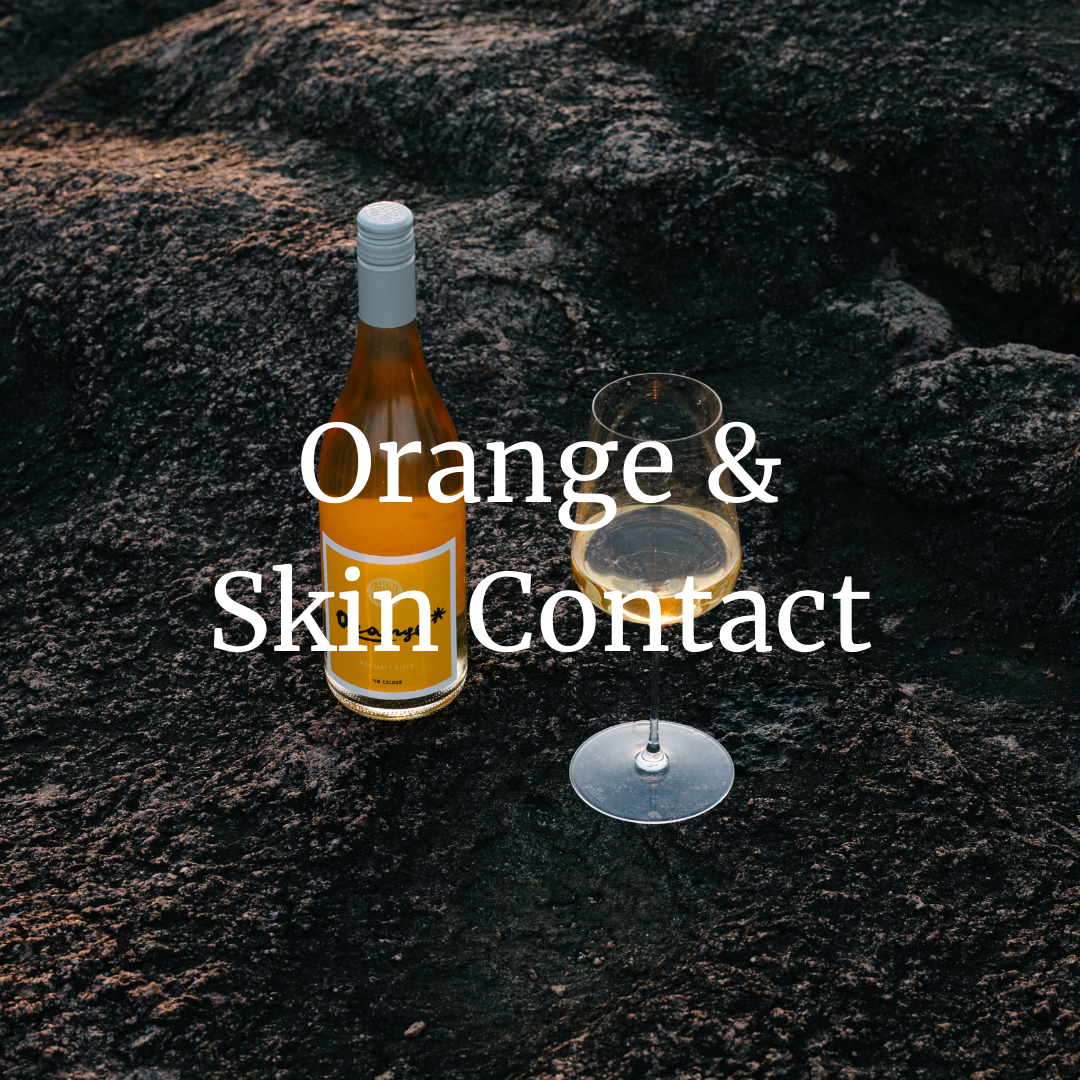 Wine bottle with an orange label on a stony background and 'Orange & Skin Contact' overlayed
